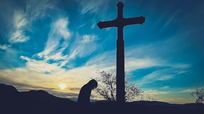 Daily Devotion - Praying with Jesus - Forgive Them- Woman kneeling at a cross