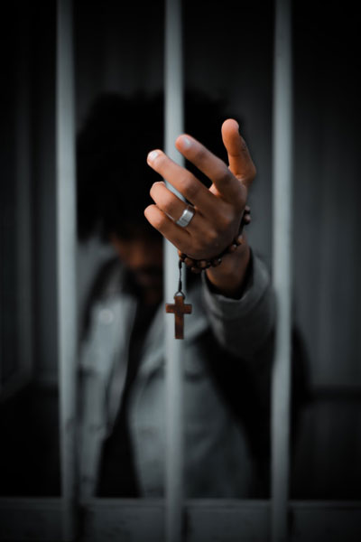 Daily Devotion - Faith Lutheran Church, Wesley Chapel, FL - Man in jail with a cross