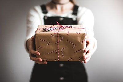 The Other Six - Faith Lutheran Church, Wesley Chapel, FL - Woman handing a gift