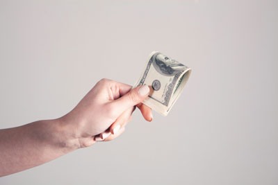 Daily Devotion - Faith Lutheran Church, Wesley Chapel, FL - A person giving money